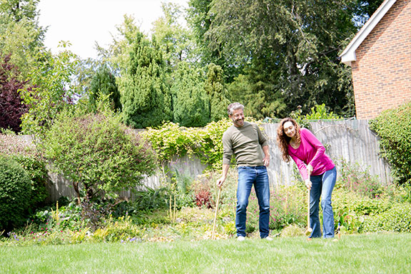 couple playing croquet on their garden lawn
