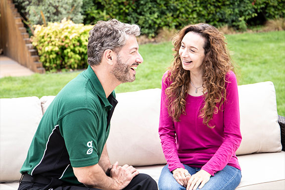 Greensleeves representative discussing a lawn renovation with a female customer