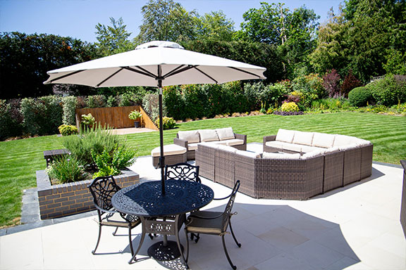 garden patio with patio furniture and green lawn in background