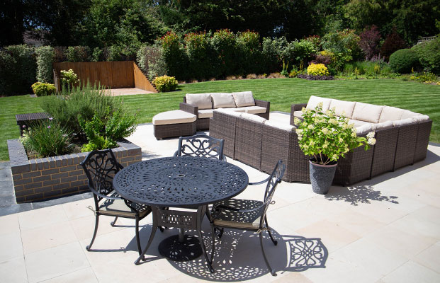 patio area with garden furniture and a lawn in the background