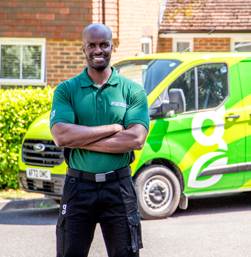 Greensleeves lawn professional stood in front of branded van