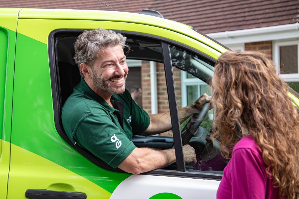 Greensleeves representative in a green van talking to a customer through the window